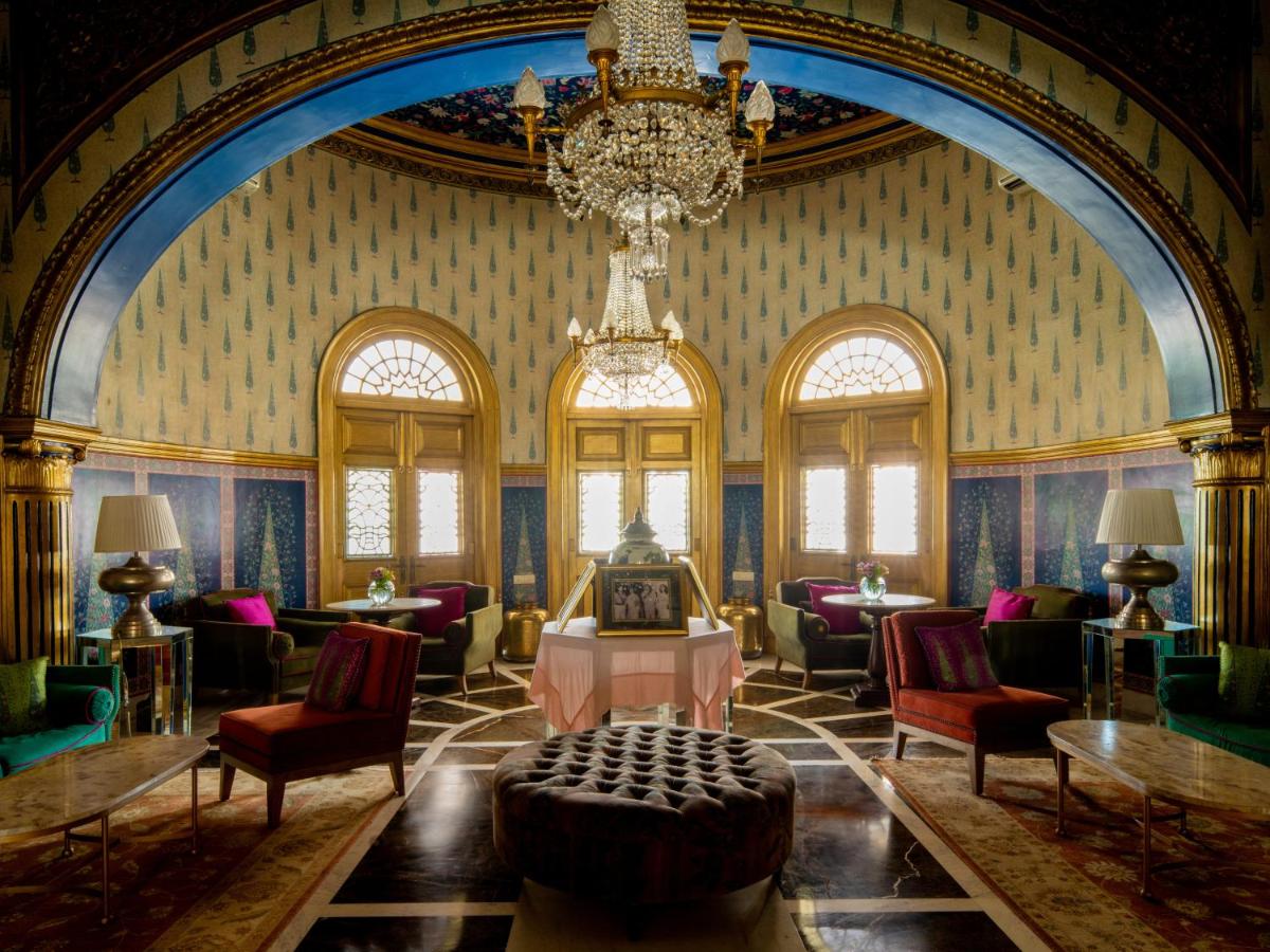 a room with a chandelier and chairs and a table at Rajmahal Palace RAAS in Jaipur