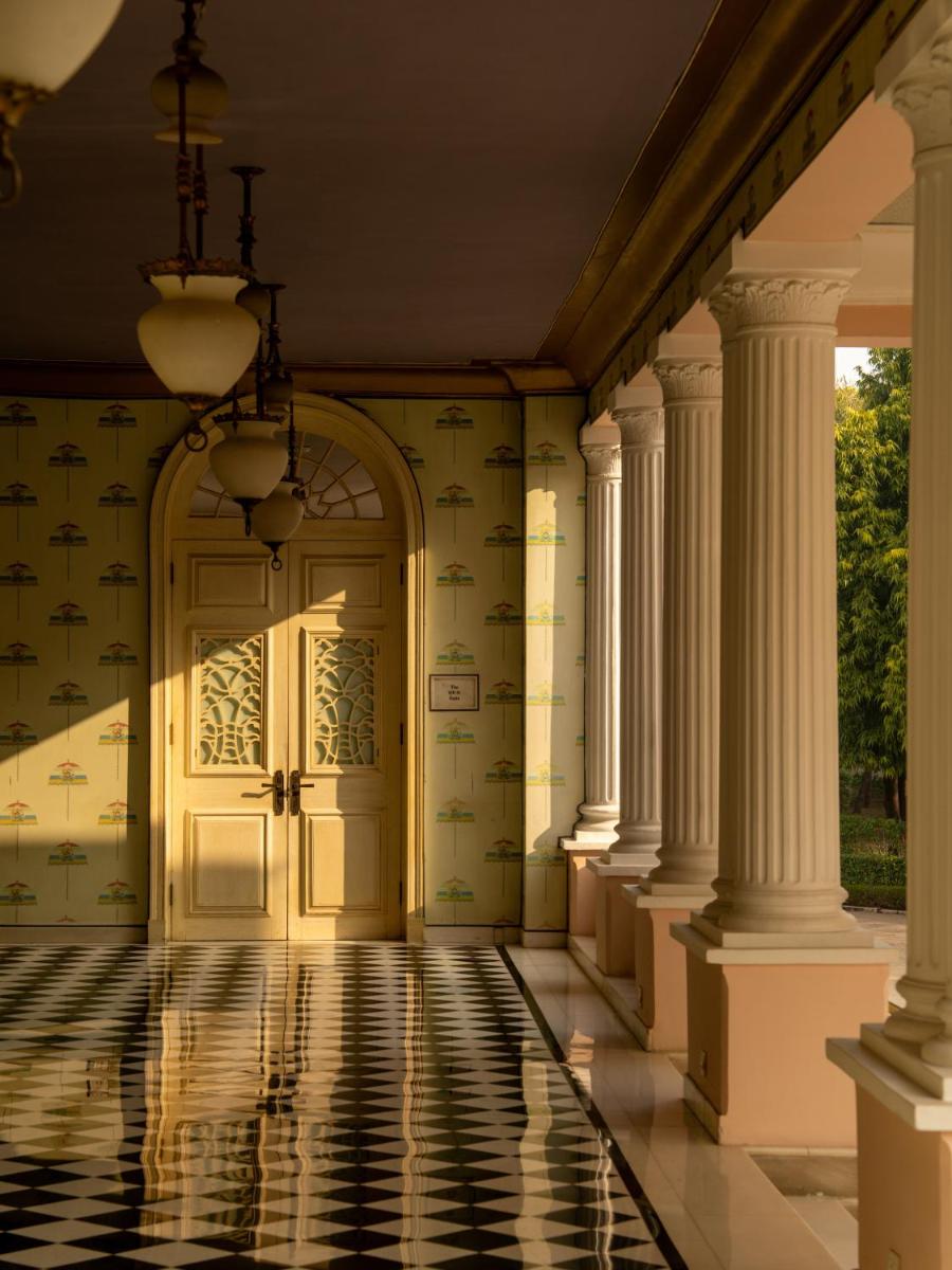 an entrance to a house with columns and a door at Rajmahal Palace RAAS in Jaipur
