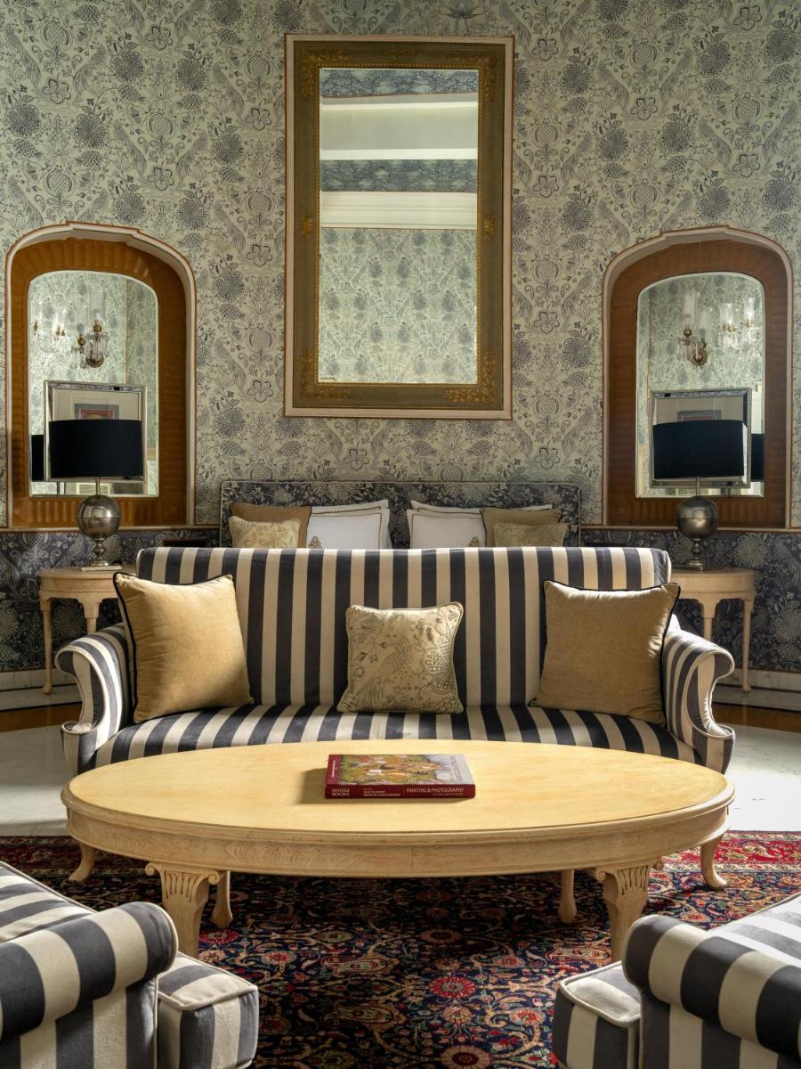 a living room with a couch and a table at Rajmahal Palace RAAS in Jaipur