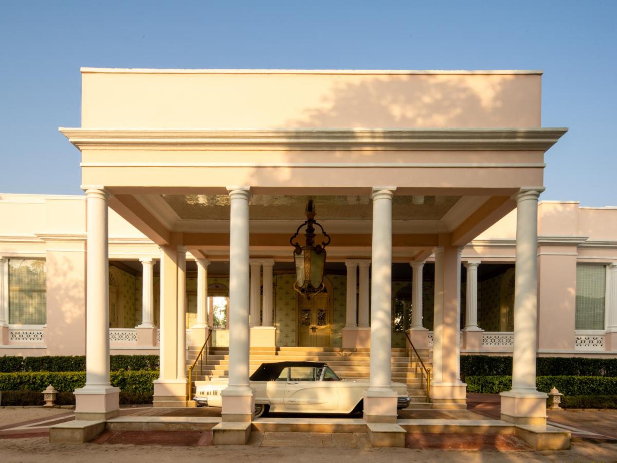 a white house with a car in front of it at Rajmahal Palace RAAS in Jaipur