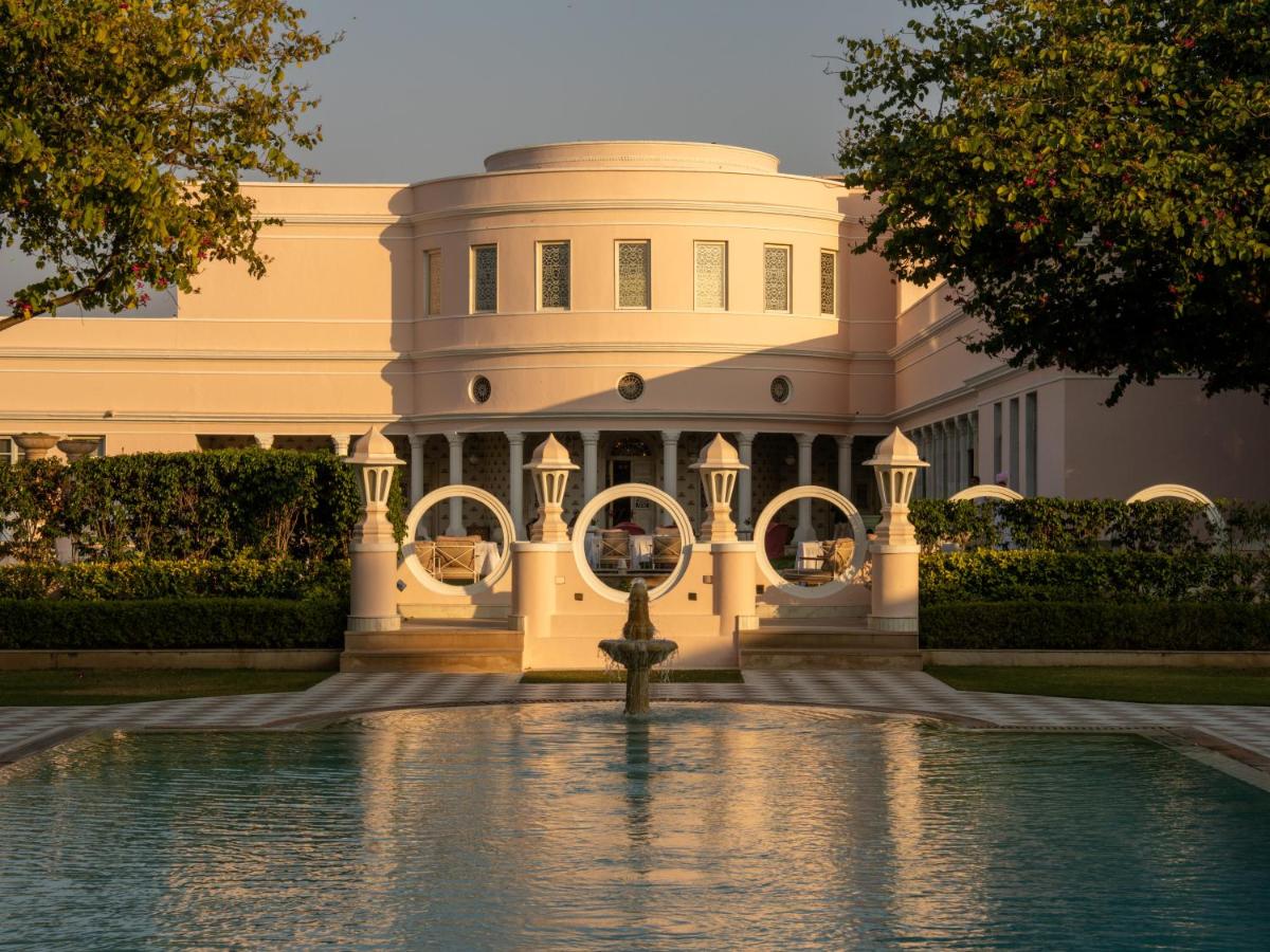 a large white building with a fountain in front of it at Rajmahal Palace RAAS in Jaipur