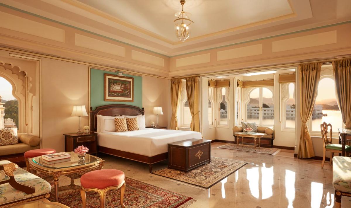 a bedroom with a bed and a living room at Taj Fateh Prakash Palace Udaipur in Udaipur