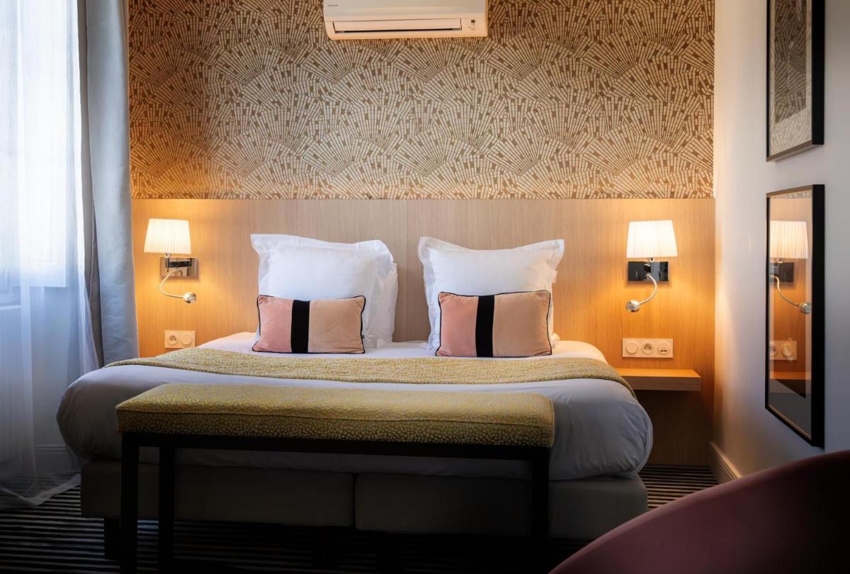 Un ou plusieurs lits dans un hébergement de l'établissement L'Aubinière Hôtel Restaurant & Spa