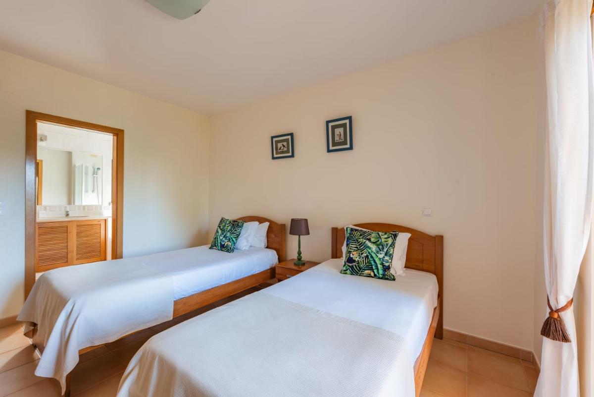 Uma cama ou camas num quarto em Estrela da Luz Resort