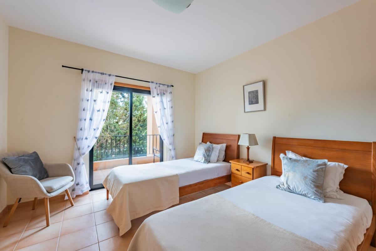 Uma cama ou camas num quarto em Estrela da Luz Resort