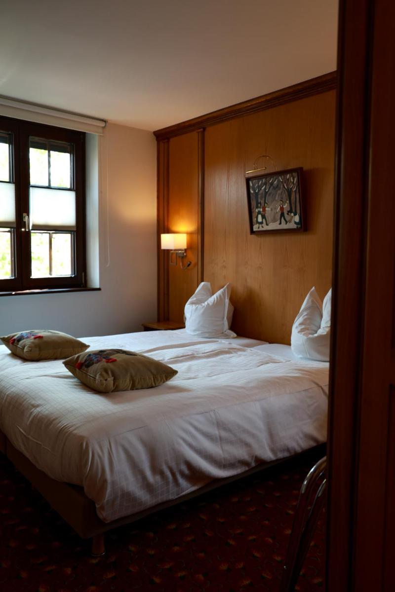 Un ou plusieurs lits dans un hébergement de l'établissement Hotel - Restaurant Le Cerf & Spa