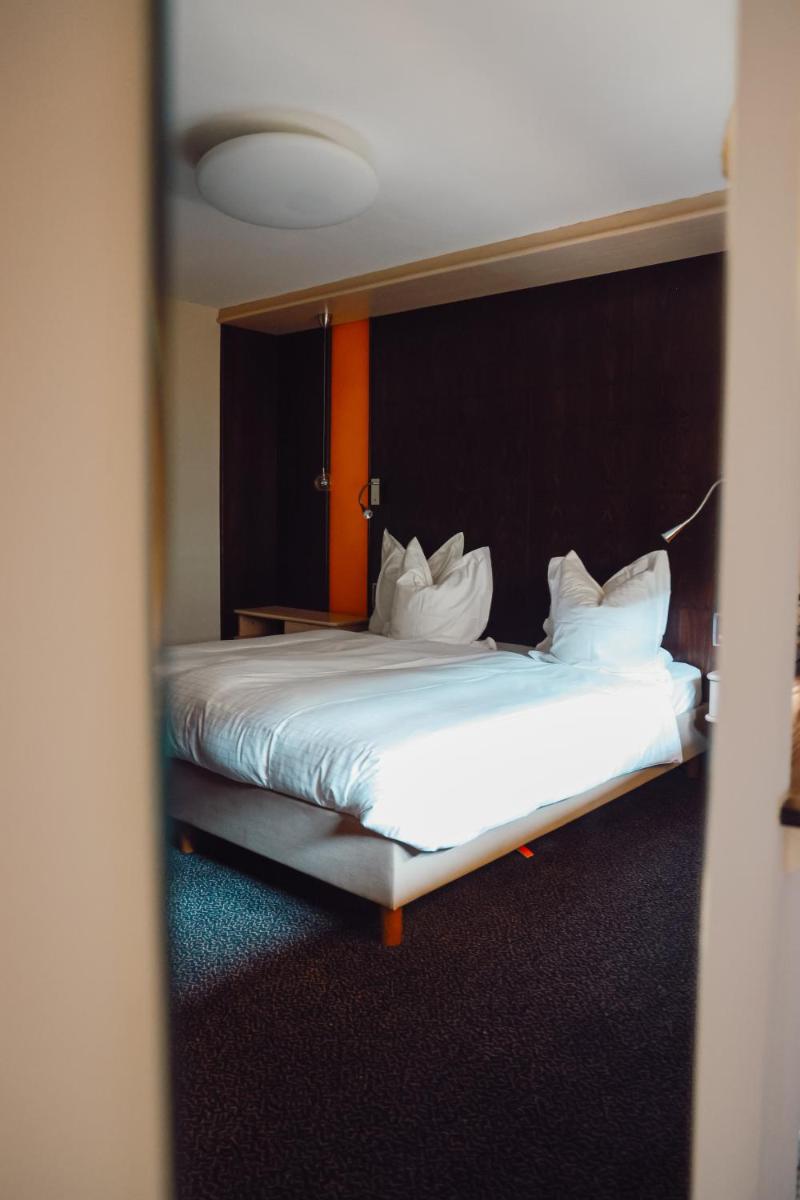 Un ou plusieurs lits dans un hébergement de l'établissement Hotel - Restaurant Le Cerf & Spa