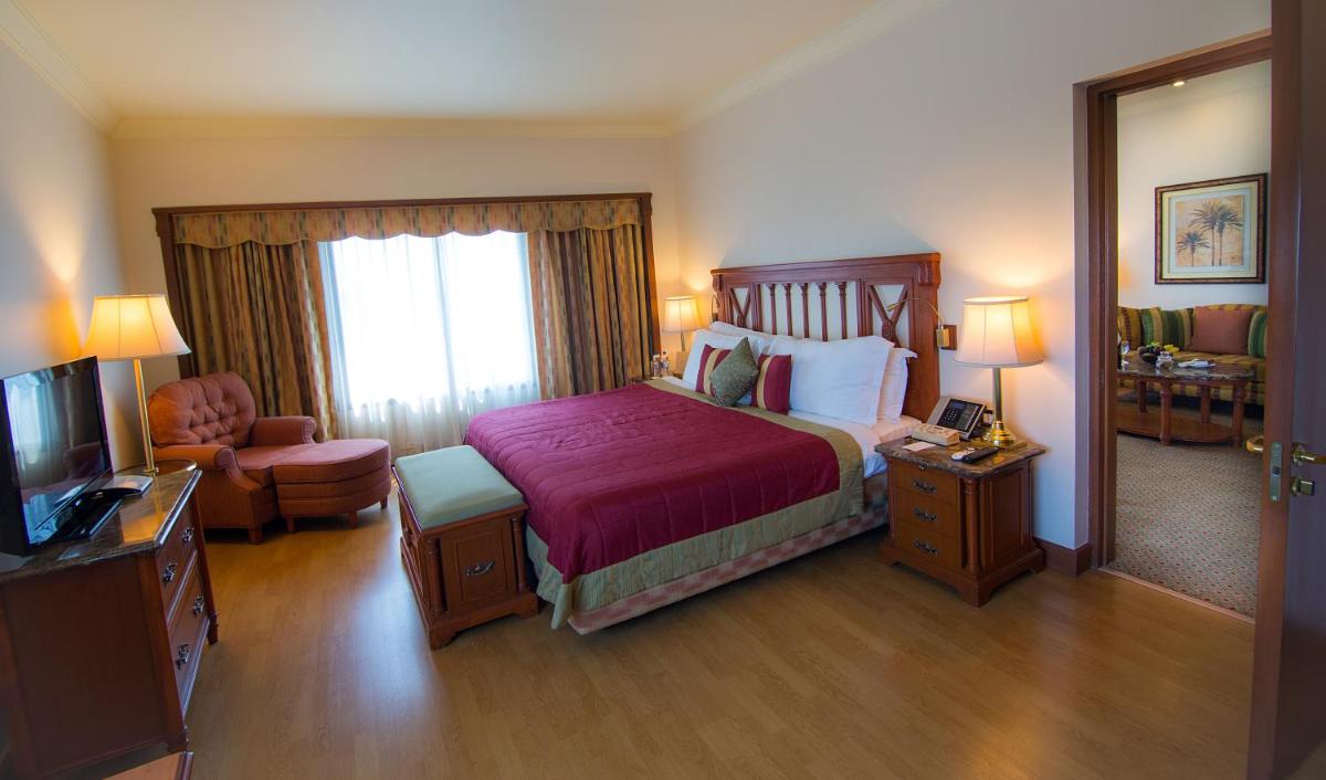 a hotel room with a bed and a television at The Orchid Hotel Mumbai Vile Parle in Mumbai