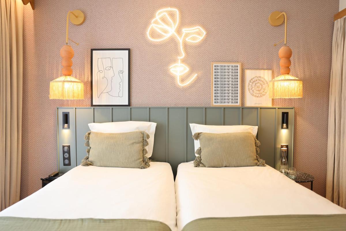 Un ou plusieurs lits dans un hébergement de l'établissement Bloom House Hôtel & SPA