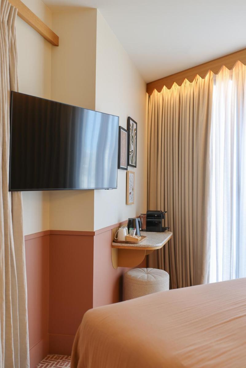 Télévision ou salle de divertissement dans l'établissement Bloom House Hôtel & SPA
