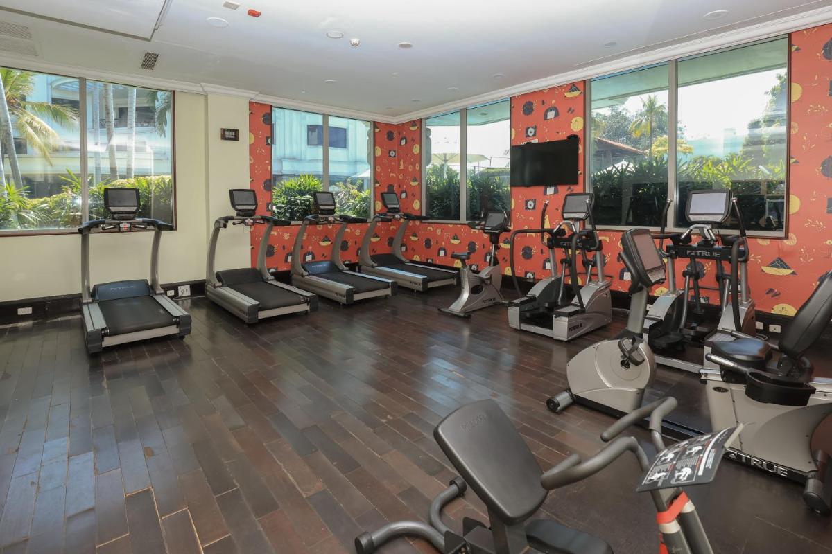 a gym with treadmills and elliptical machines at Le Royal Meridien Chennai in Chennai