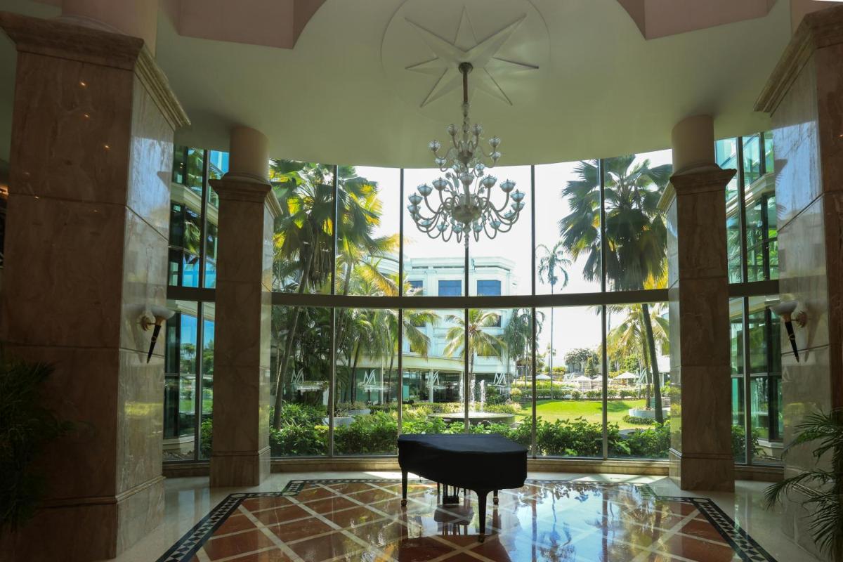 a large room with a chandelier and a chair at Le Royal Meridien Chennai in Chennai