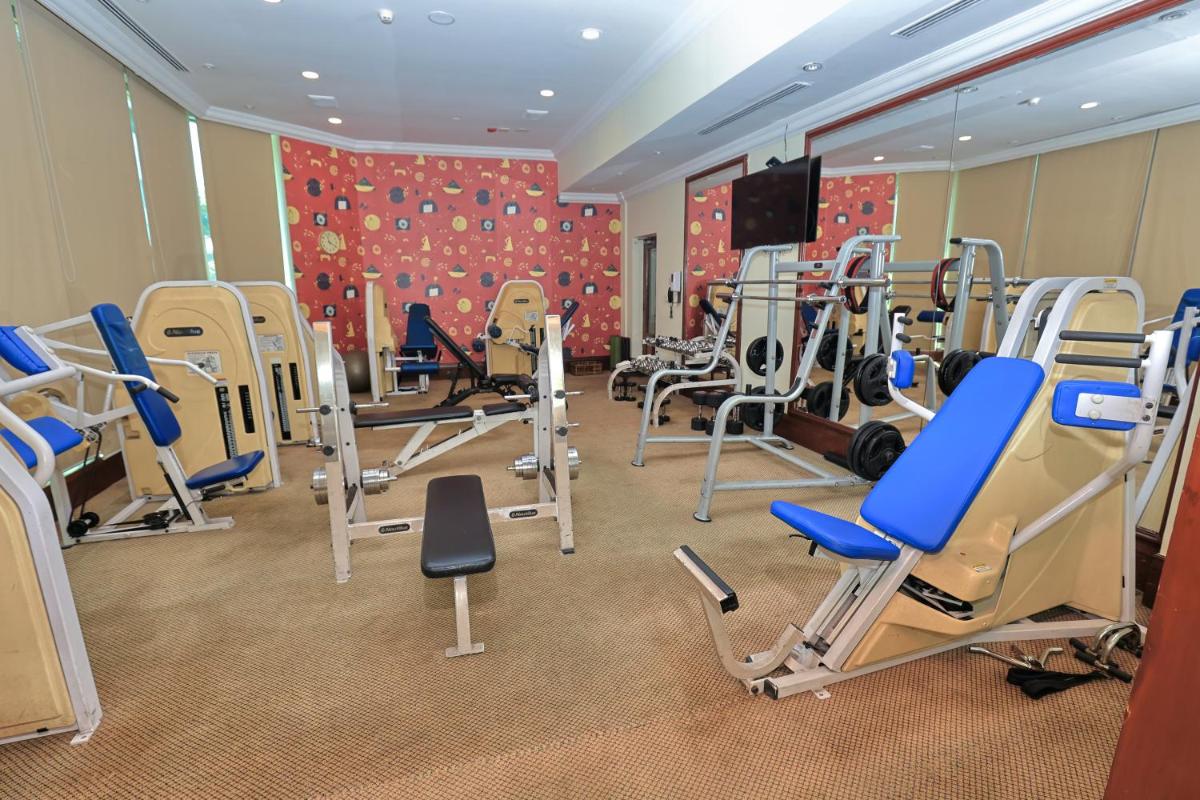 a gym with a bunch of tread machines in it at Le Royal Meridien Chennai in Chennai