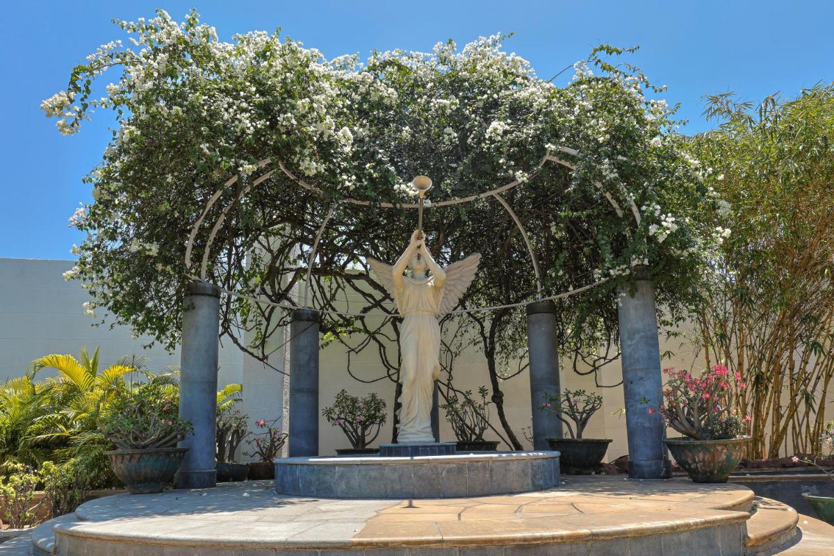 a statue of a woman sitting on top of a fountain at Le Royal Meridien Chennai in Chennai