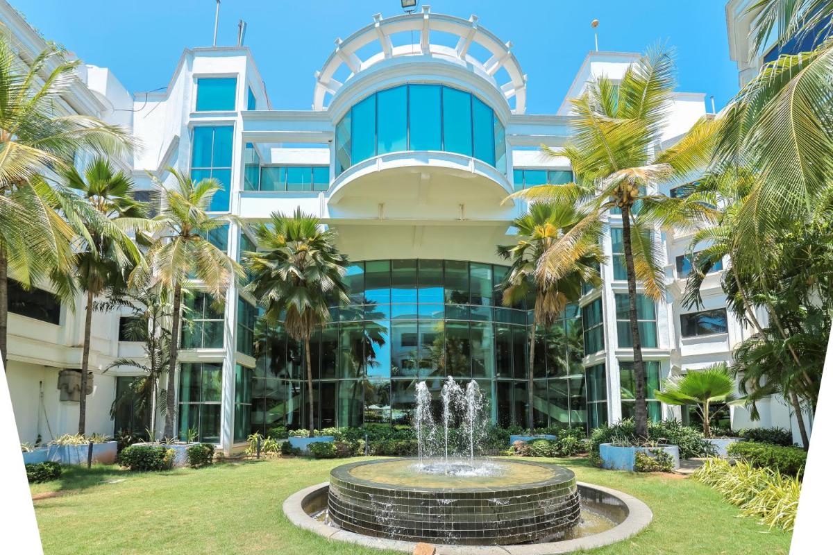 a building with a fountain in front of it at Le Royal Meridien Chennai in Chennai