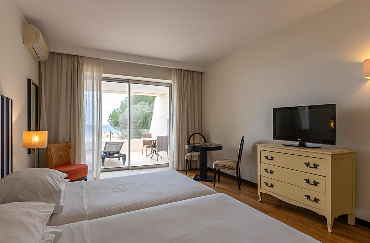 Uma cama ou camas num quarto em Pestana Alvor Praia Premium Beach & Golf Resort