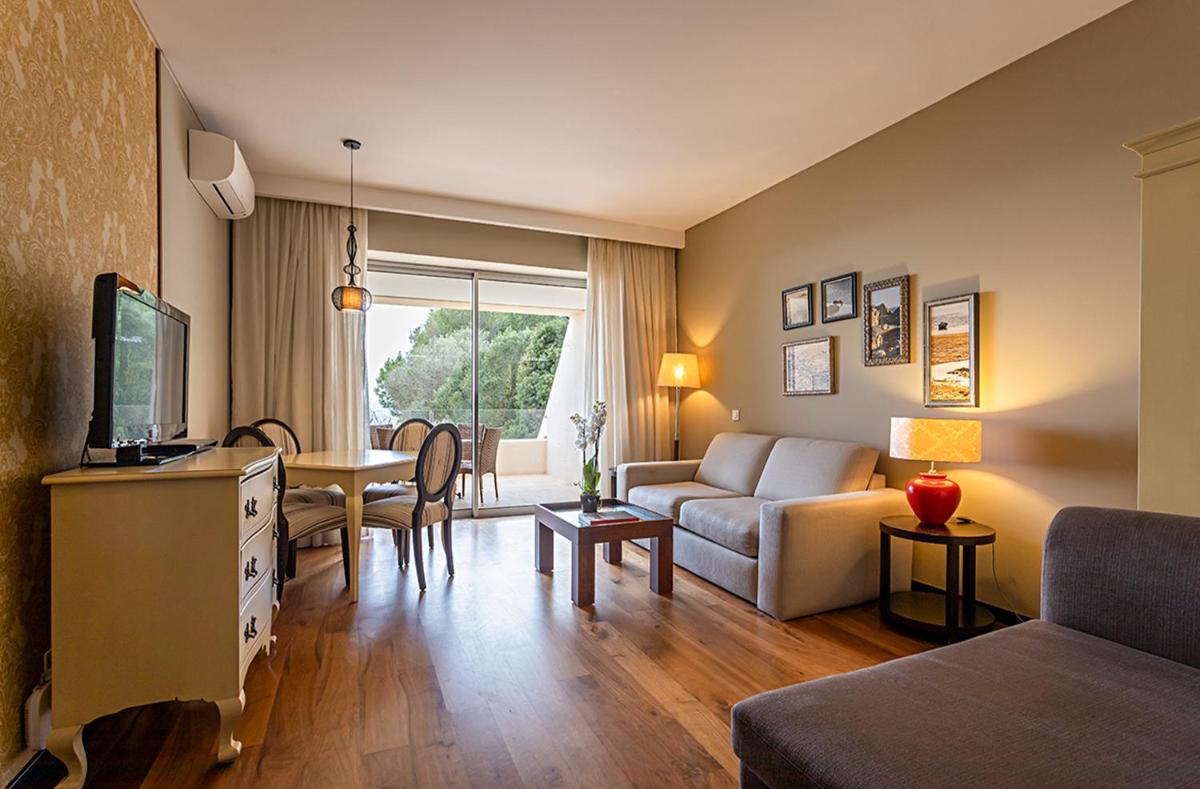 uma sala de estar com um sofá e uma mesa em Pestana Alvor Praia Premium Beach & Golf Resort em Alvor