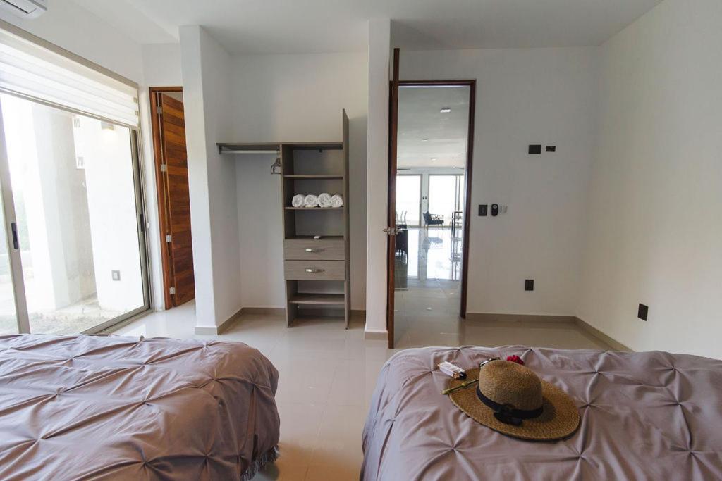 Angelina 28 Beachfront and Family Apartments - Modern and Relaxing Long Stays - 20 min from Cancun Airport - Housity