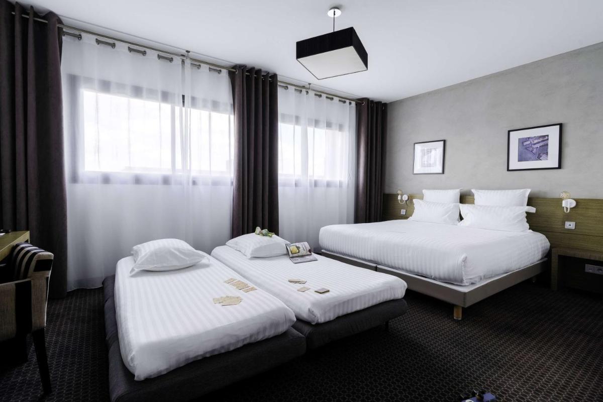 Un ou plusieurs lits dans un hébergement de l'établissement Best Western Hôtel De La Cité & Spa