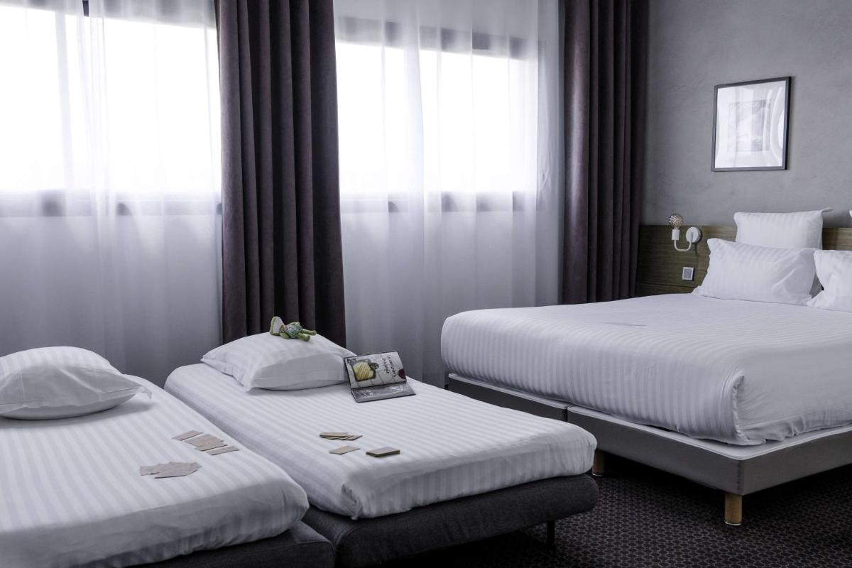 Un ou plusieurs lits dans un hébergement de l'établissement Best Western Hôtel De La Cité & Spa