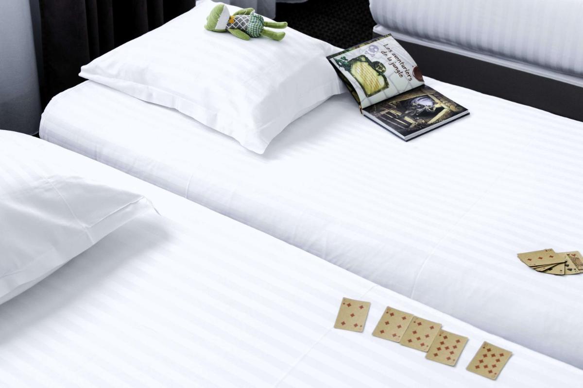 Un ou plusieurs lits dans un hébergement de l'établissement Best Western Hôtel De La Cité & Spa