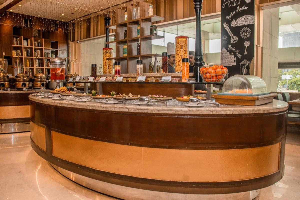 a bar in a restaurant with a counter at Holiday Inn Jaipur City Centre by IHG in Jaipur a bar in a restaurant with a counter at Holiday Inn Jaipur City Centre by IHG in Jaipur