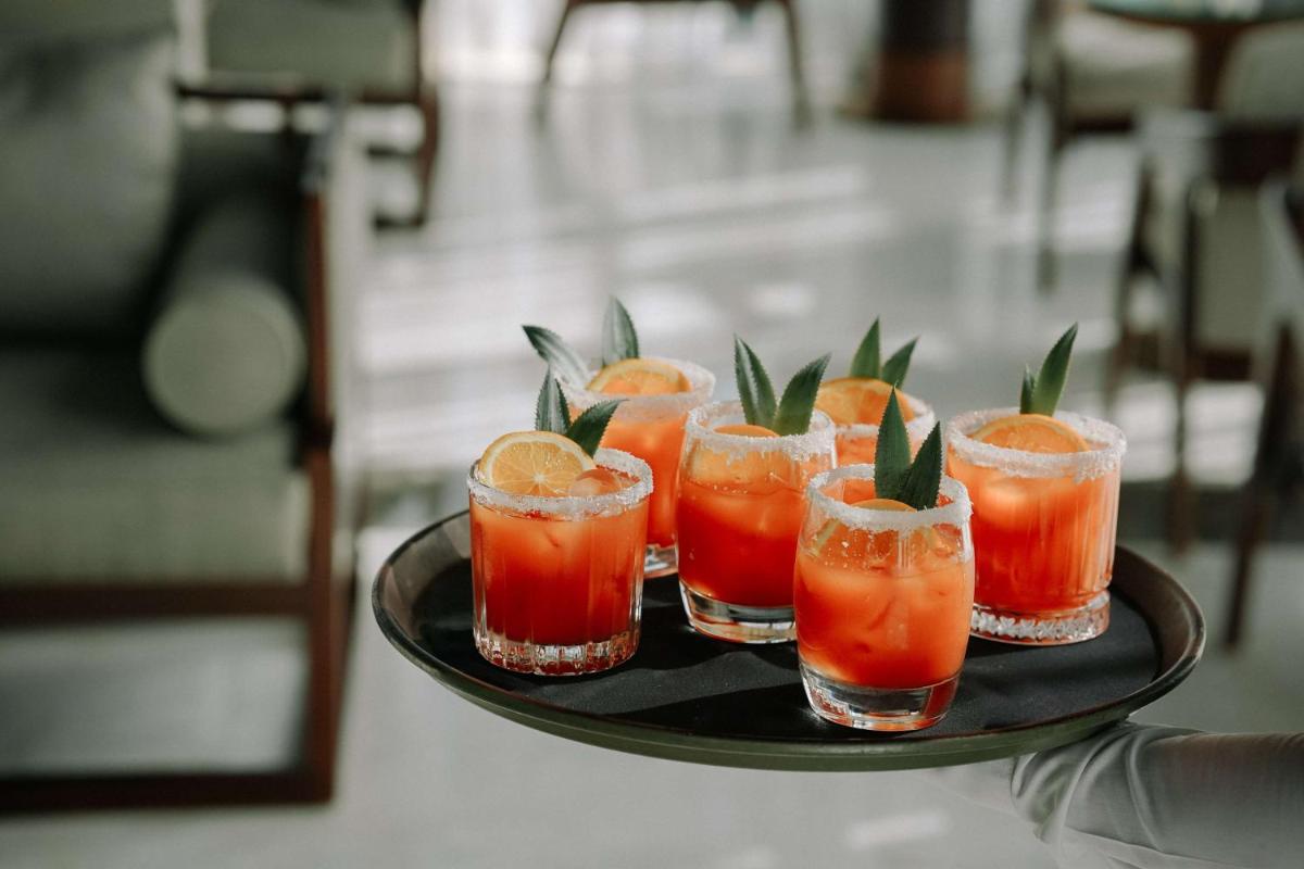 a tray with four cocktails on a table at Radisson Blu Hotel Amritsar in Amritsar