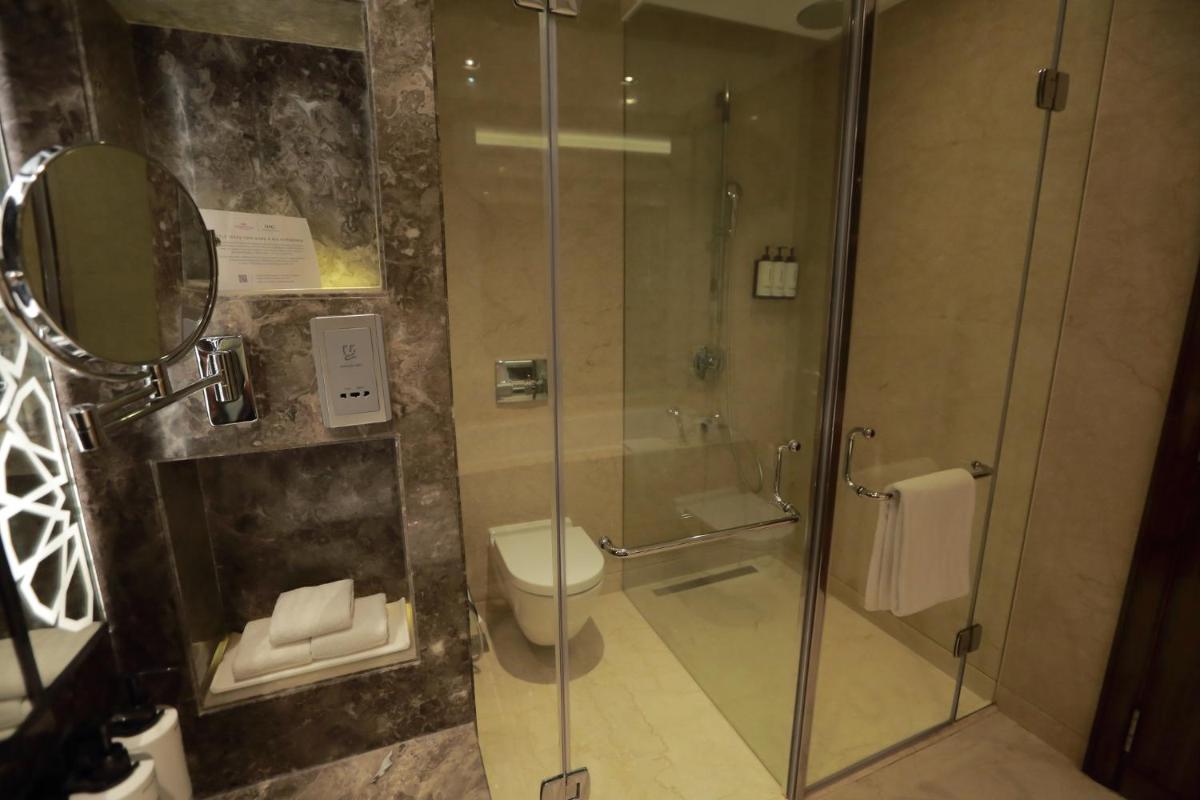 a bathroom with a glass shower with a toilet at Crowne Plaza New Delhi Rohini by IHG in New Delhi a bathroom with a glass shower with a toilet at Crowne Plaza New Delhi Rohini by IHG in New Delhi