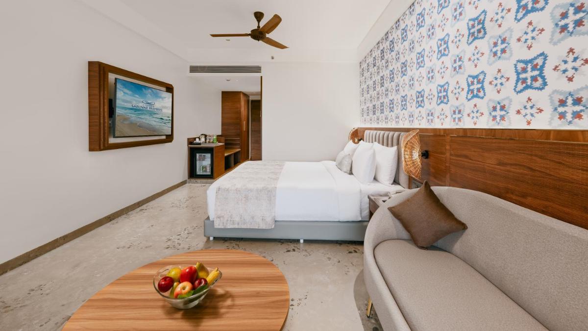 a hotel room with a bed and a bowl of fruit on a table at Gateway Goa, Palolem in Palolem