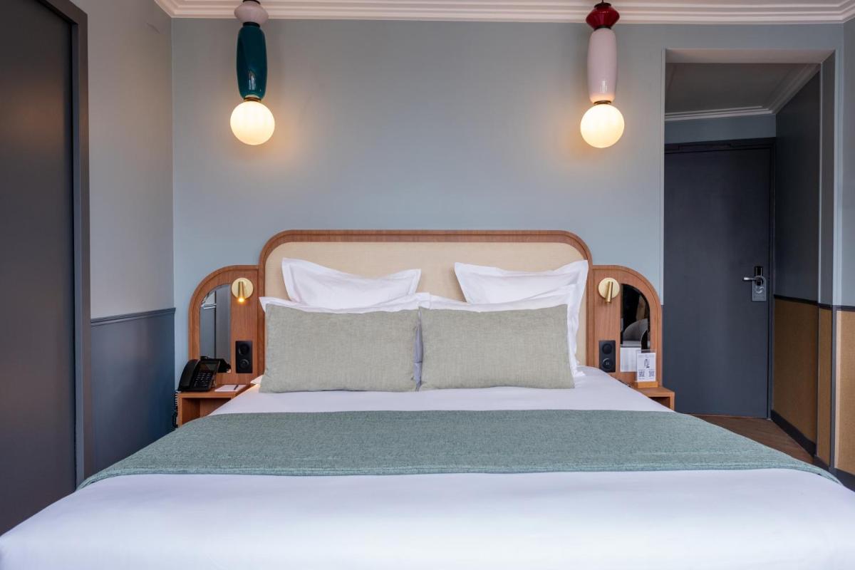 Un ou plusieurs lits dans un hébergement de l'établissement Grand Hotel Saint Michel