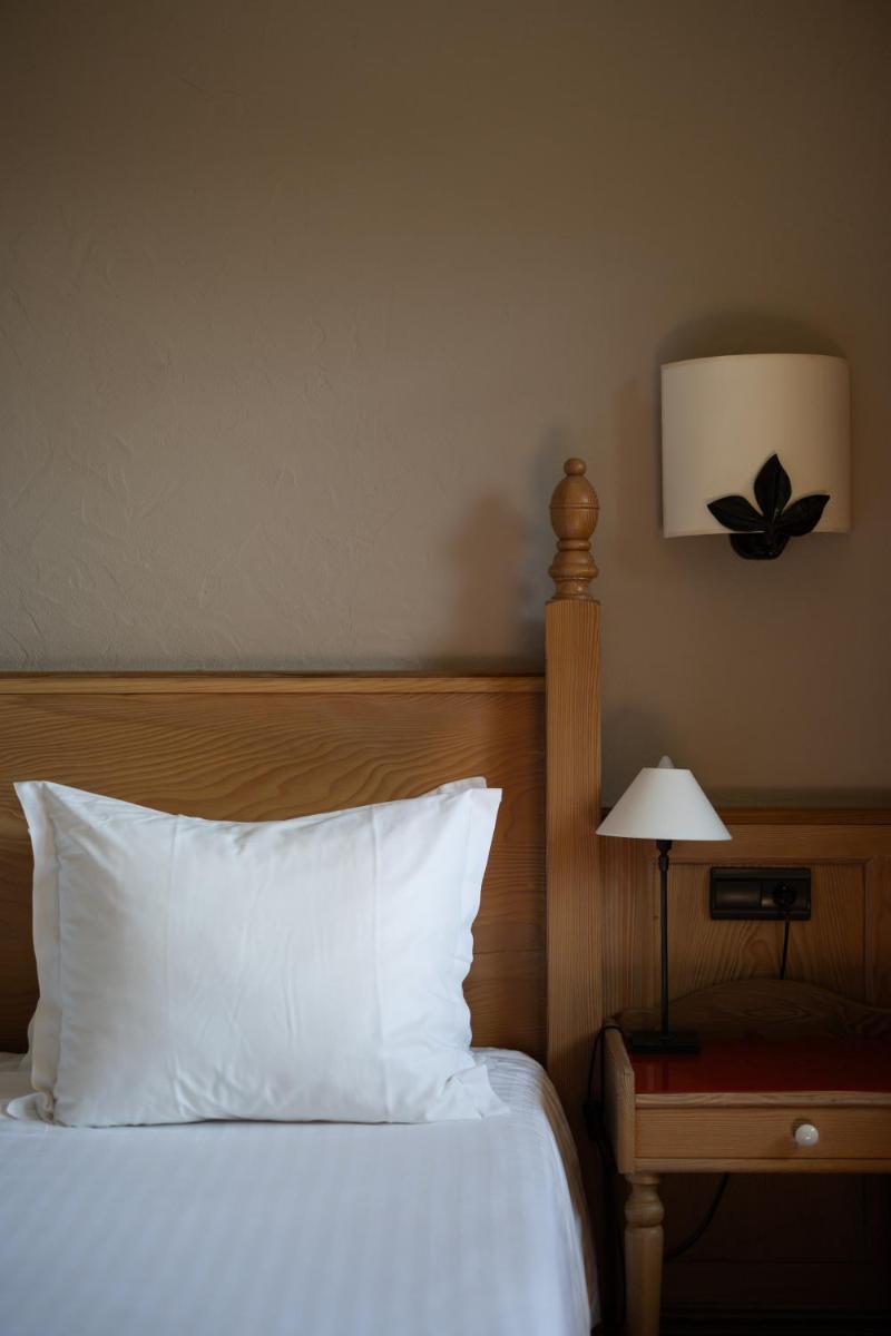 Un ou plusieurs lits dans un hébergement de l'établissement Hôtel Arnold