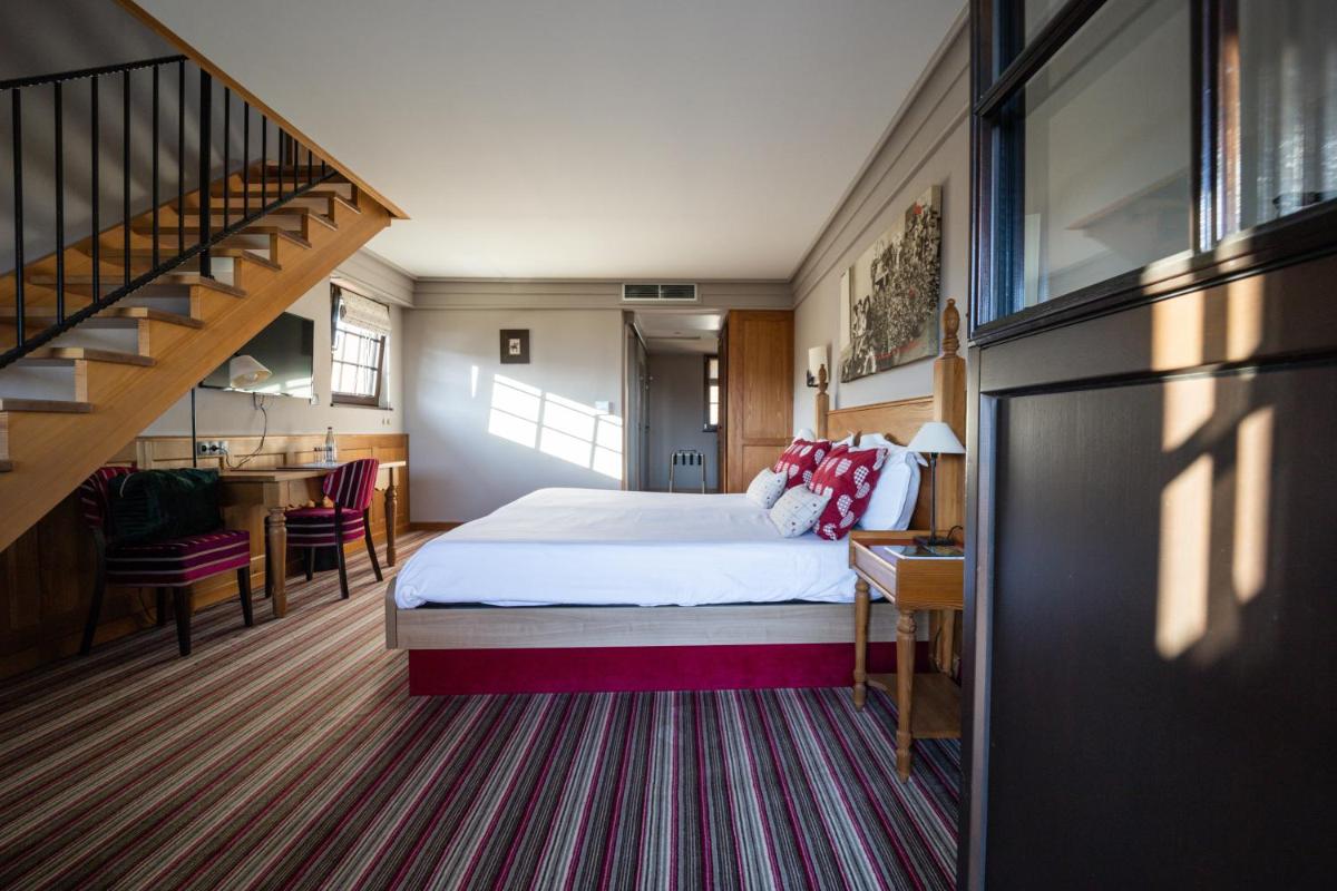 Un ou plusieurs lits dans un hébergement de l'établissement Hôtel Arnold