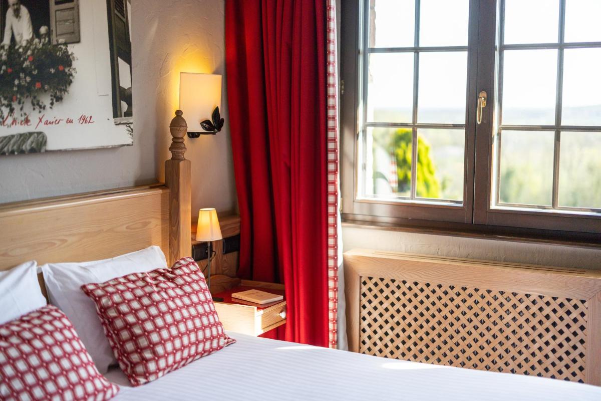 Un ou plusieurs lits dans un hébergement de l'établissement Hôtel Arnold