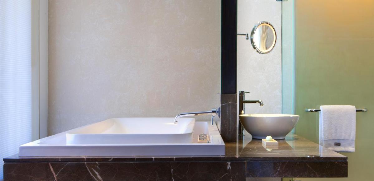 a bathroom with a sink and a bowl on a counter at The Westin Hyderabad Mindspace in Hyderabad