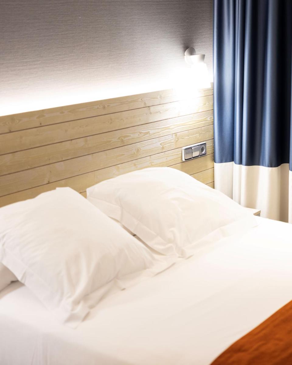 Cama o camas de una habitación en Hotel Avenida