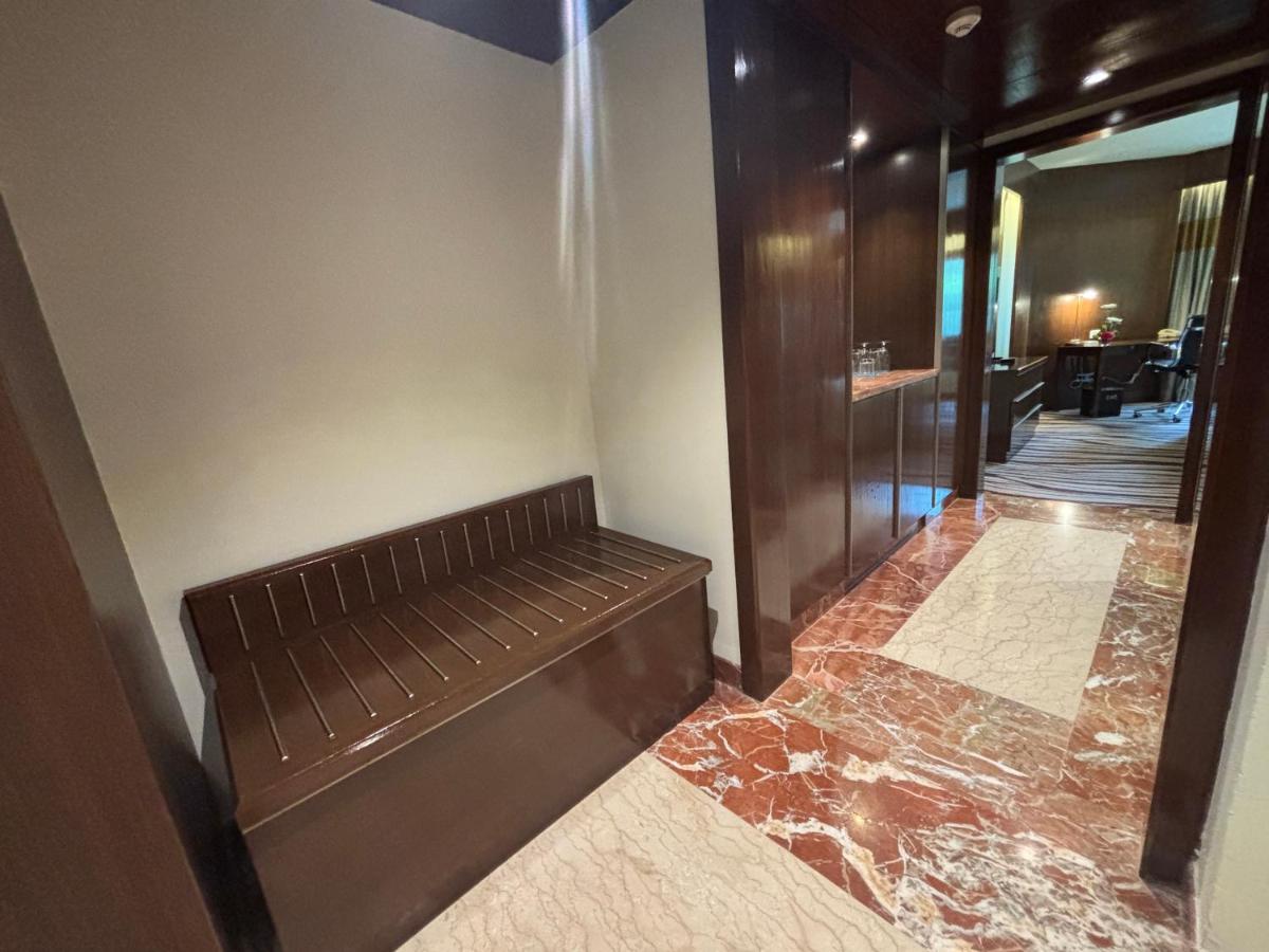 a hallway with a bench in a building at Le Royal Meridien Chennai in Chennai