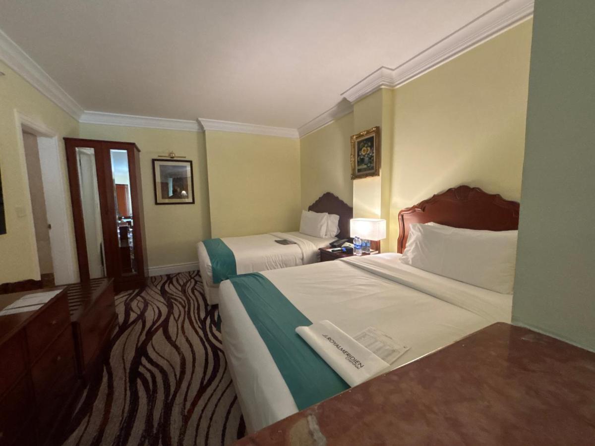 a hotel room with two beds and a window at Le Royal Meridien Chennai in Chennai