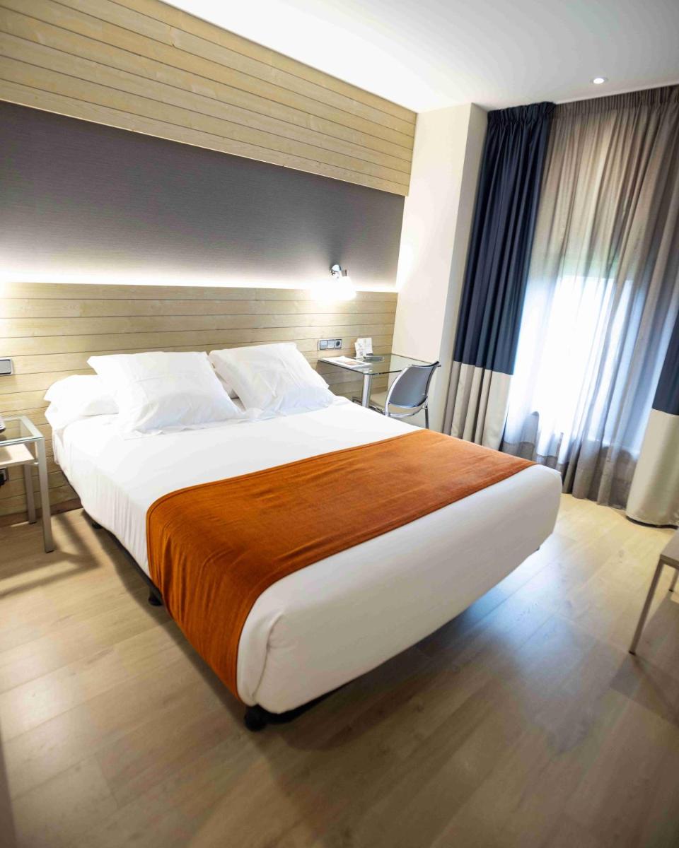 Cama o camas de una habitación en Hotel Avenida