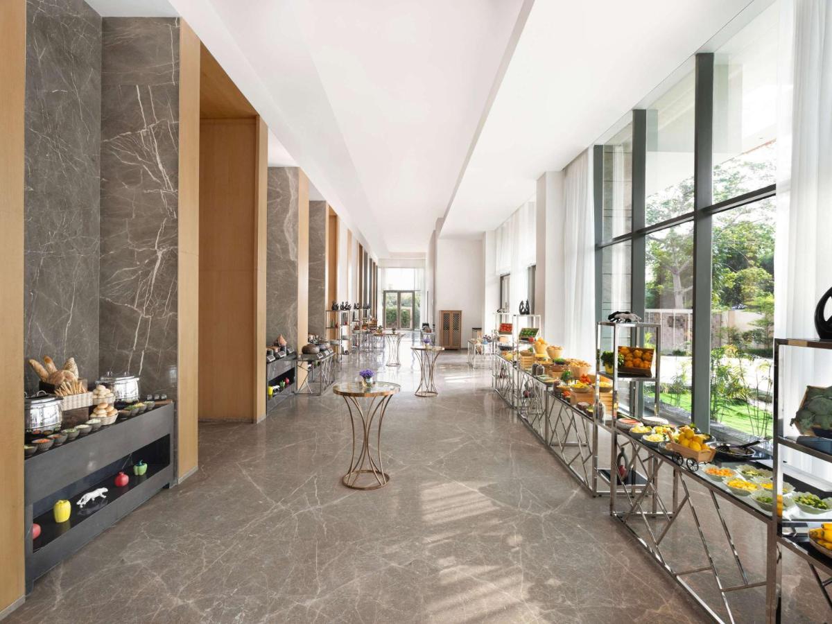 a lobby with a buffet line in a building at Novotel New Delhi City Centre in New Delhi a lobby with a buffet line in a building at Novotel New Delhi City Centre in New Delhi