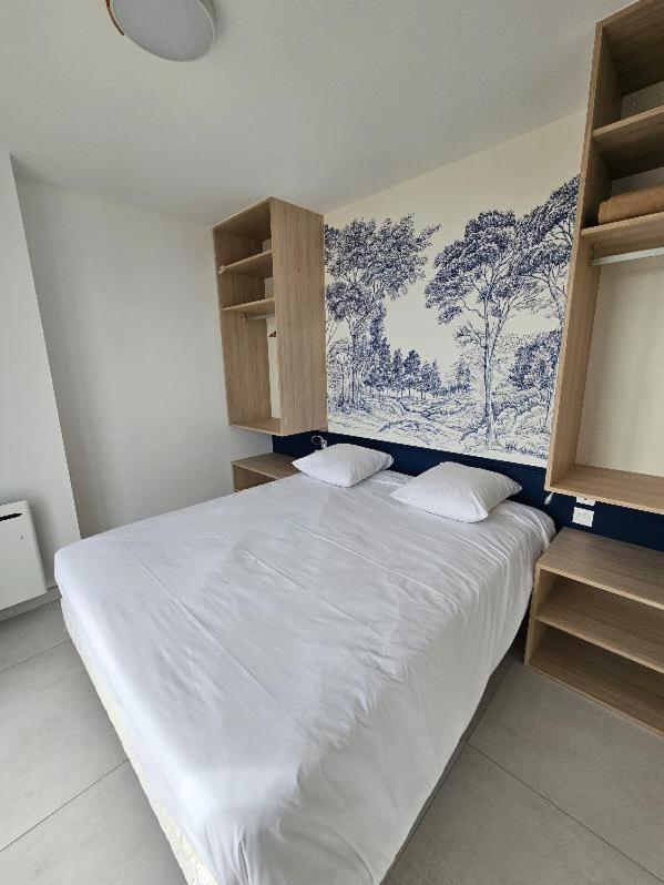 Un ou plusieurs lits dans un hébergement de l'établissement Hotel Les Dunes