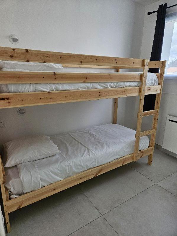 Un ou plusieurs lits dans un hébergement de l'établissement Hotel Les Dunes