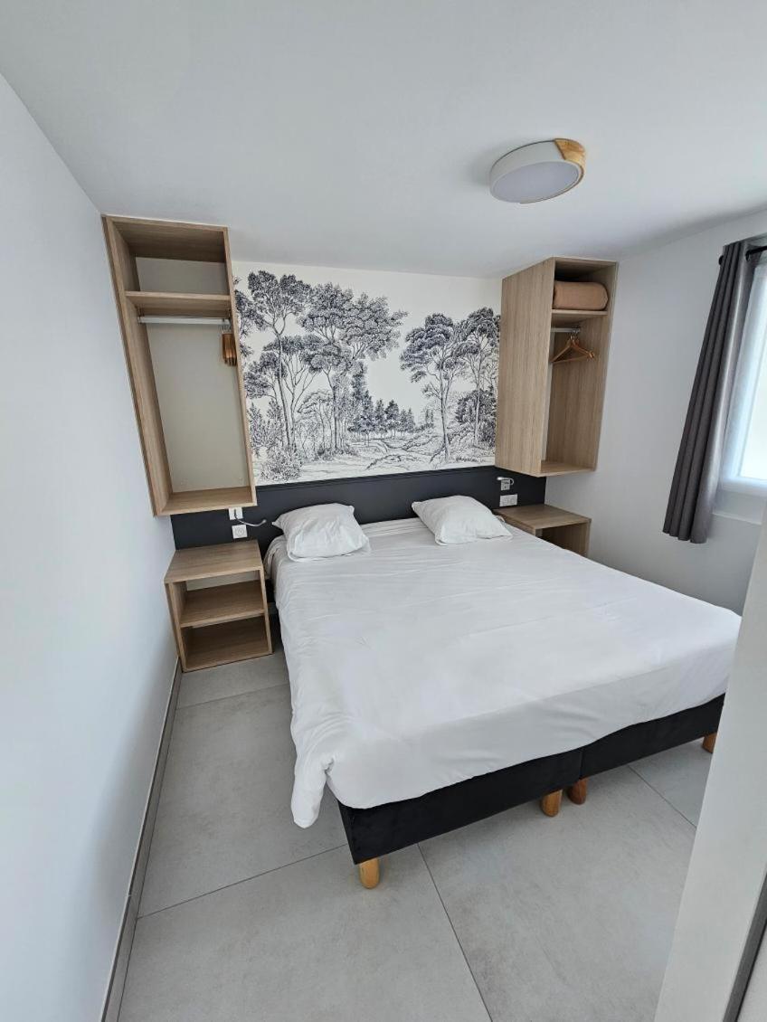 Un ou plusieurs lits dans un hébergement de l'établissement Hotel Les Dunes
