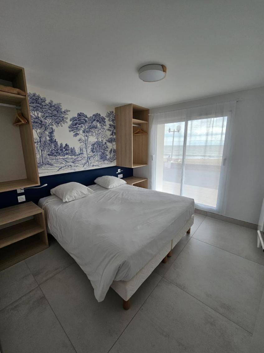 Un ou plusieurs lits dans un hébergement de l'établissement Hotel Les Dunes
