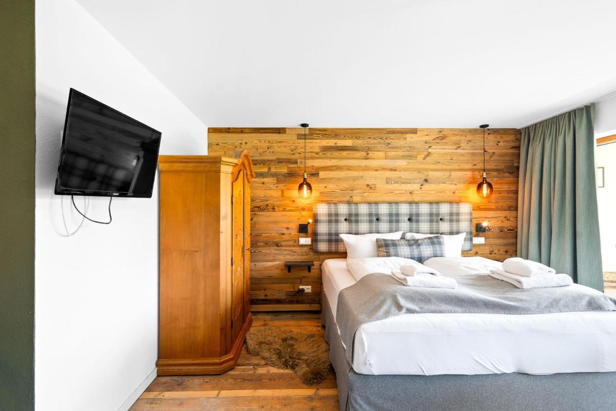 Ein Bett oder Betten in einem Zimmer der Unterkunft Soho Mountain Chalet - Pool und Sauna