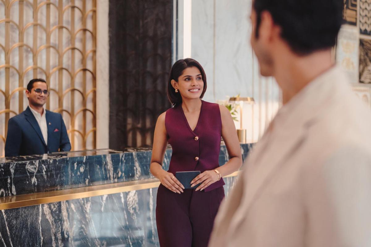 a woman standing in front of a man at Fairmont Mumbai in Mumbai