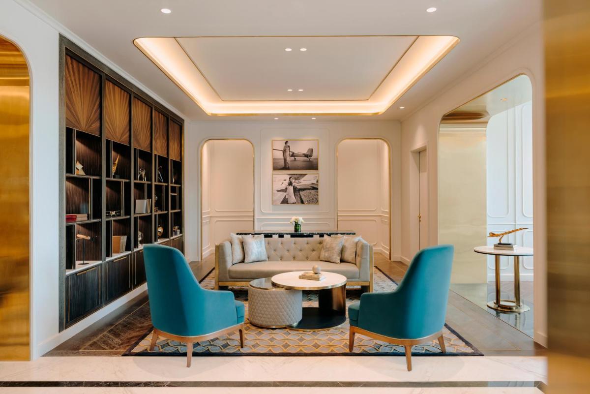 a living room with a couch and chairs at Fairmont Mumbai in Mumbai