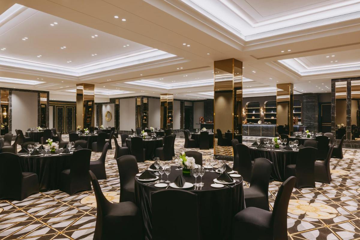 a ballroom with tables and chairs in a room with ceilings at Fairmont Mumbai in Mumbai