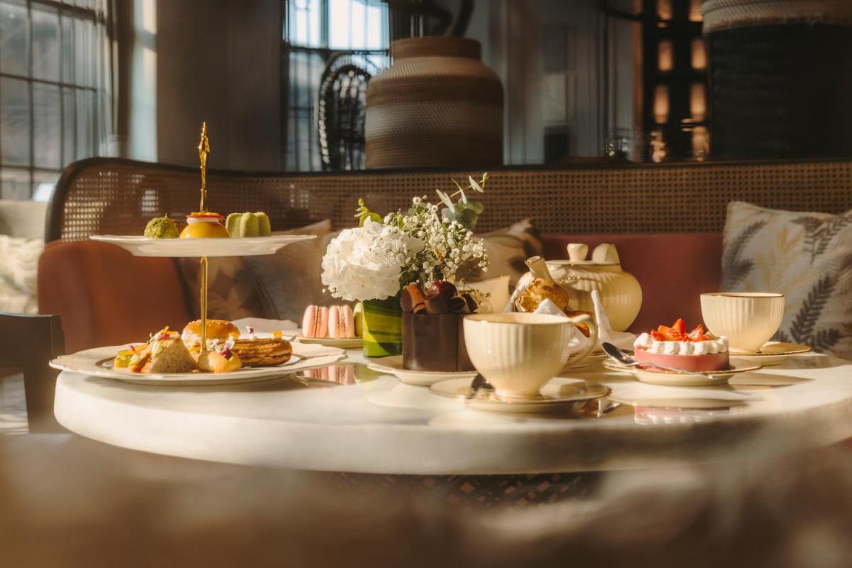 a table with plates of food and cups of coffee at Fairmont Mumbai in Mumbai