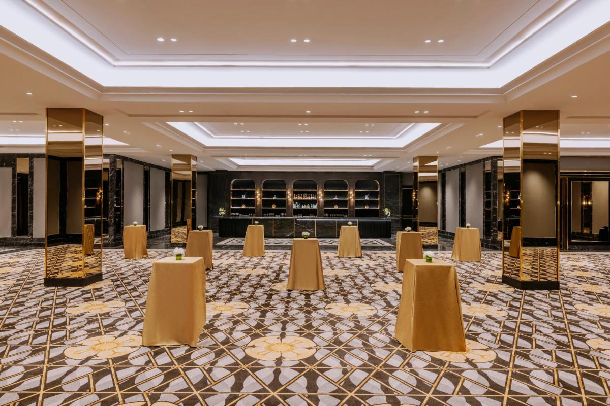 a ballroom with tables and chairs in a building at Fairmont Mumbai in Mumbai