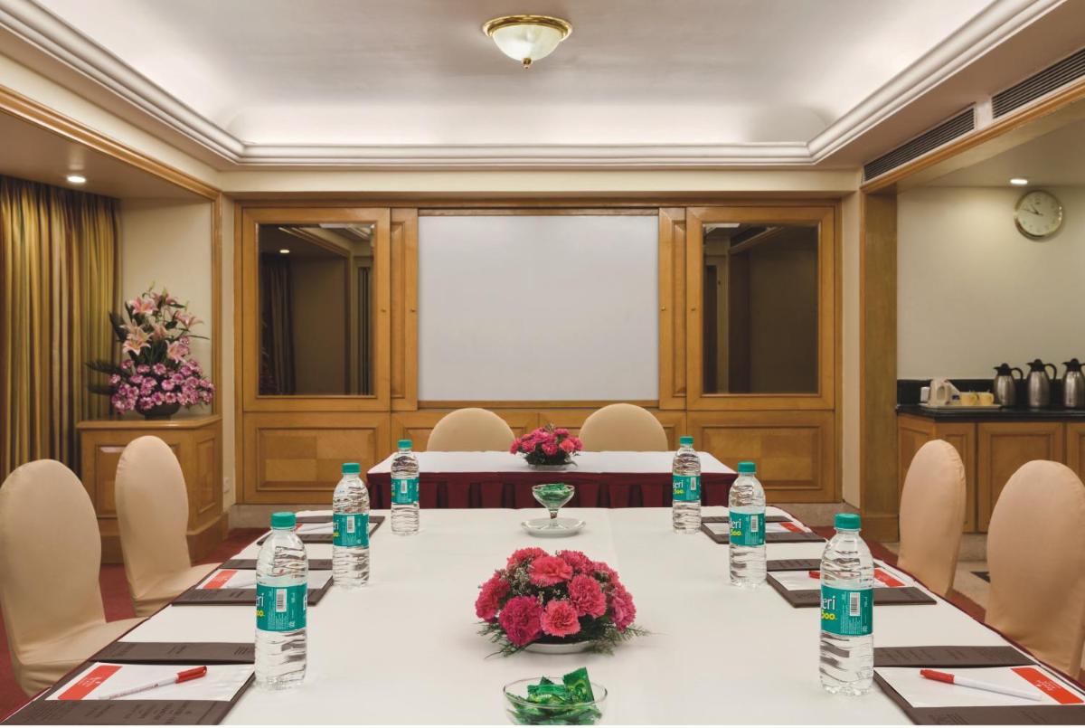 a meeting room with a long table with water bottles at Ramada Plaza By Wyndham Palm Grove in Mumbai